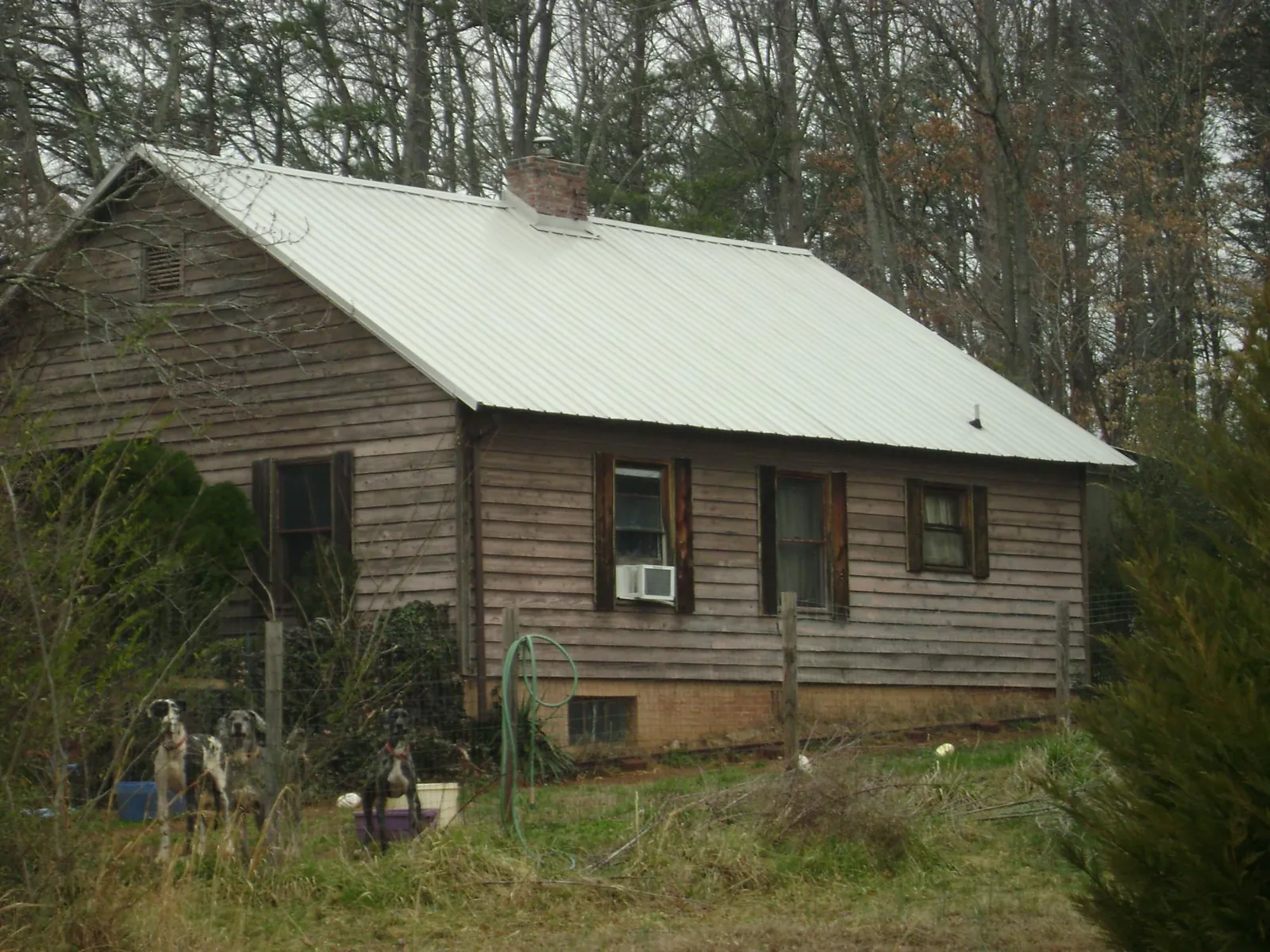 White metal roof on an old wood sided farmhouse, from a Metal Roof Installation job in Rushville